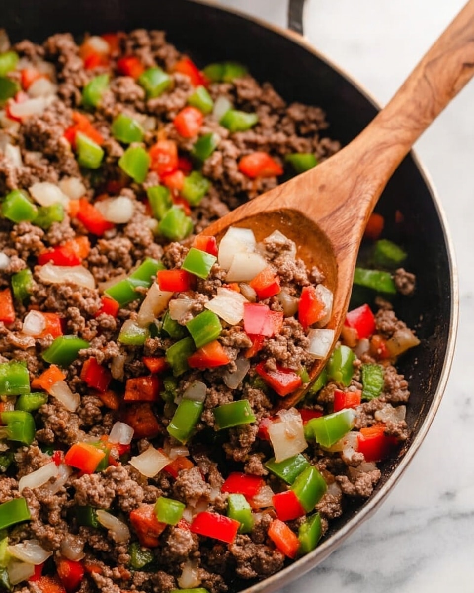 A close-up of a black pan filled with cooked ground beef mixed with diced green bell peppers, red bell peppers, and white onions. A wooden spoon is scooping a portion of the mixture, showing the colorful, soft, and slightly shiny pieces of vegetables mixed evenly with the cooked beef. The pan sits on a white marbled surface. Photo taken with an iphone --ar 4:5 --v 7