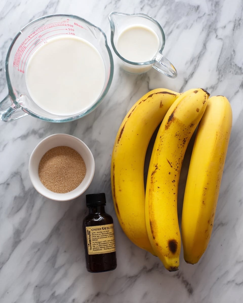 A bunch of five bright yellow bananas with some brown spots rests on a white marbled surface. Near the bananas, there is a small clear measuring cup filled halfway with white milk, and next to it, a larger clear measuring cup that is empty. Below these, there is a small white bowl filled with light brown sugar, and beside it lies a dark brown bottle with a label, which is vanilla extract. photo taken with an iphone --ar 4:5 --v 7