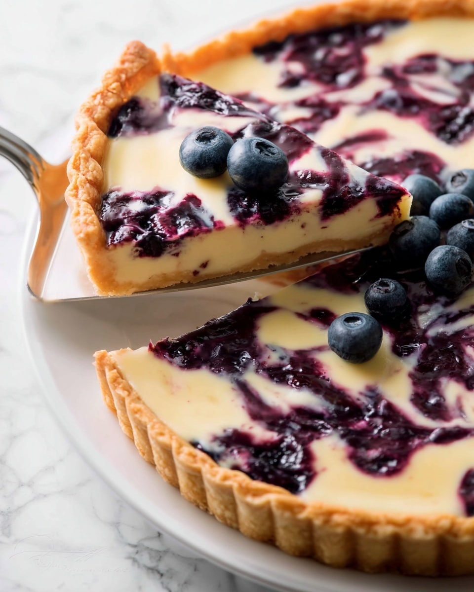 A tart with one layer of light golden crust with a crimped edge on the bottom, topped by a creamy pale yellow filling swirled with dark purple blueberry sauce creating a marbled effect, finished with a few whole fresh blueberries scattered on top, served on a white plate resting on a white marbled surface, with a silver pie server lifting one slice slightly outward photo taken with an iphone --ar 4:5 --v 7