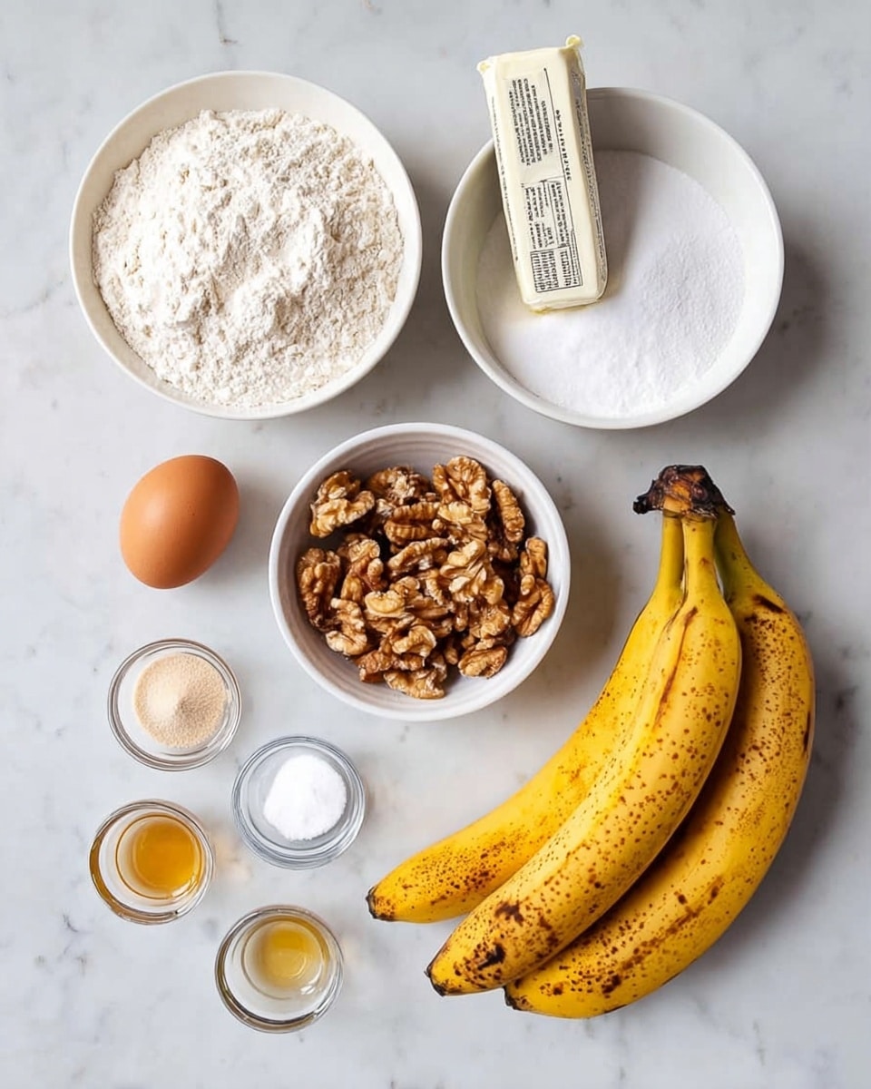 The image shows 11 baking ingredients arranged on a white marbled surface. There are three ripe yellow bananas with brown spots on the bottom right. Above the bananas, there's a small, wrapped stick of butter in a white wrapper with black text. To the left of the butter, a single brown egg rests on the surface. Above the egg, a white bowl filled with white flour is placed. To the right of the flour bowl, there is a white bowl filled with white granulated sugar. Below the flour bowl, a white bowl holds light brown walnut halves. On the bottom left corner, four small clear bowls are lined up, containing a light golden liquid, white powder, white powder, a white powder with some texture, and a light brown powder, respectively. A small amount of coarse white salt is also visible near these bowls. photo taken with an iphone --ar 4:5 --v 7