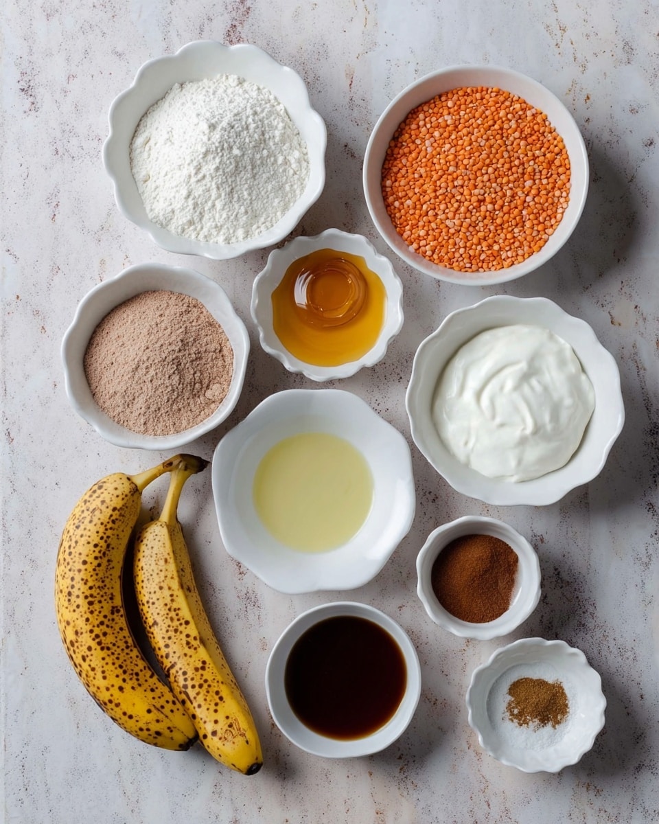 The image shows nine white bowls arranged neatly on a white marbled surface, each holding different baking ingredients. The largest bowl near the top left holds a fine white flour, next to it a smaller bowl contains orange lentils with a rough texture. Below these, a bowl of golden honey is centered. Adjacent are a bowl with light brown powder, a bowl of thick white yogurt with a creamy texture, and a bowl with a dark brown liquid, likely vanilla extract. Two eggs rest in a small white scalloped bowl, and a clear pale yellow oil fills another bowl beside them. Two ripe bananas with brown spots lie on the surface near the bottom left. The last bowl holds a few white powders and brown spices together. photo taken with an iphone --ar 4:5 --v 7