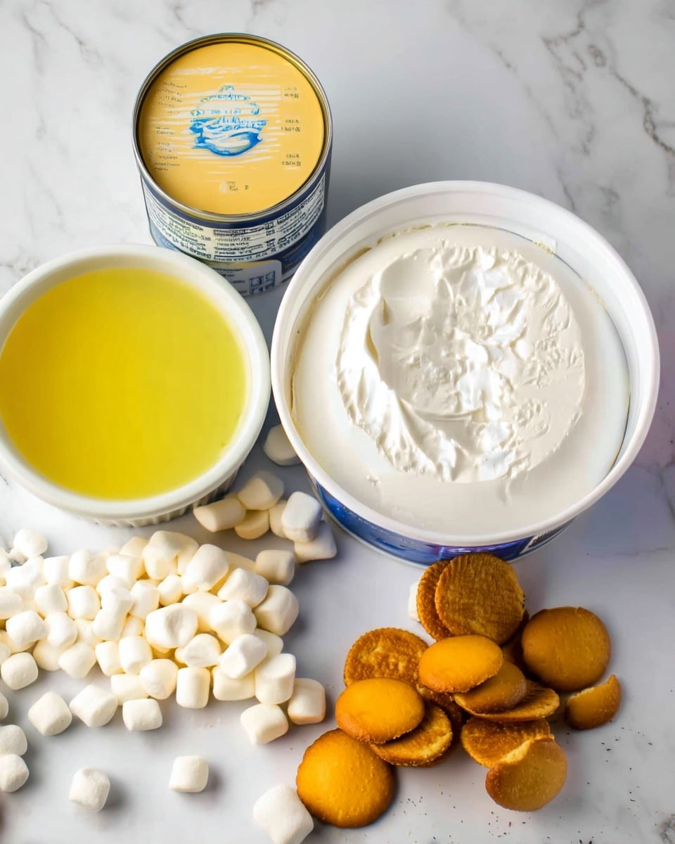 The image shows an open container of smooth white cream cheese at the center. To the left of the container, there is a small white bowl filled with yellow liquid, likely melted butter. Near that bowl, there is a yellow tin can with a blue label. On the white marbled surface around the container, there are many small white mini marshmallows spread out, especially on the left side. On the right side of the container, a pile of round, thin, golden-brown vanilla wafer cookies is placed, some stacked and some scattered. The overall scene is bright and clean with a focus on these baking ingredients. photo taken with an iphone --ar 4:5 --v 7