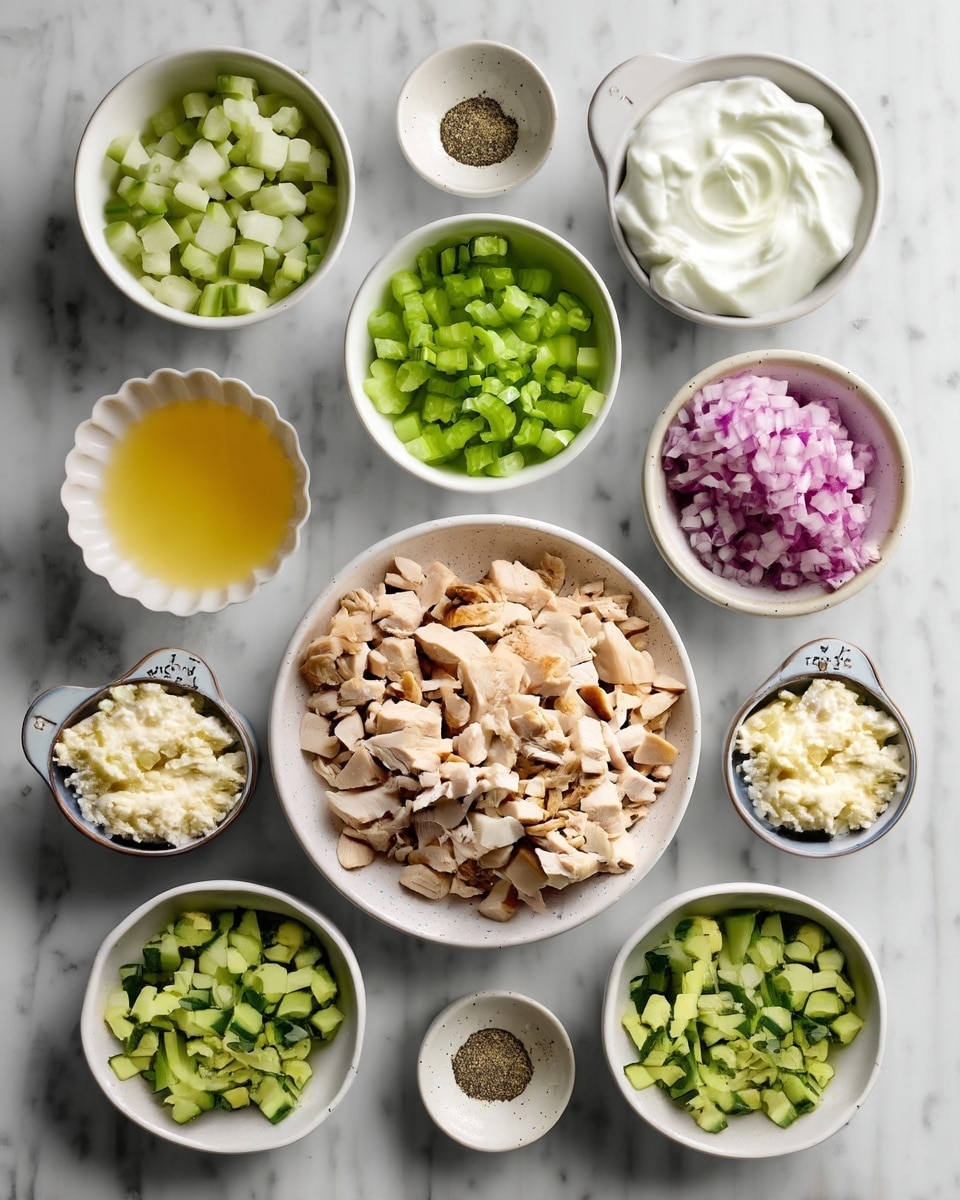 The image shows eleven small white bowls arranged on a white marbled surface, each filled with different ingredients. In the center, a large white bowl holds chopped cooked chicken, beige with a slight browning. Around it are smaller bowls with green diced celery, green diced cucumber, finely chopped herbs in dark green, and finely chopped red onion with a purple and white mix. Another bowl contains a pale yellow liquid, while a different bowl holds thick white yogurt with creamy swirls. There are also small bowls with crumbled white cheese, grated light green cucumber, minced light yellow garlic, white salt, and black pepper. The scene is clean and well organized with soft natural light. photo taken with an iphone --ar 4:5 --v 7